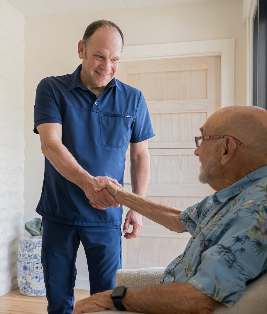 Chad Johnson, L.Ac., greeting a patient at Asheville Orthopedic Acupuncture